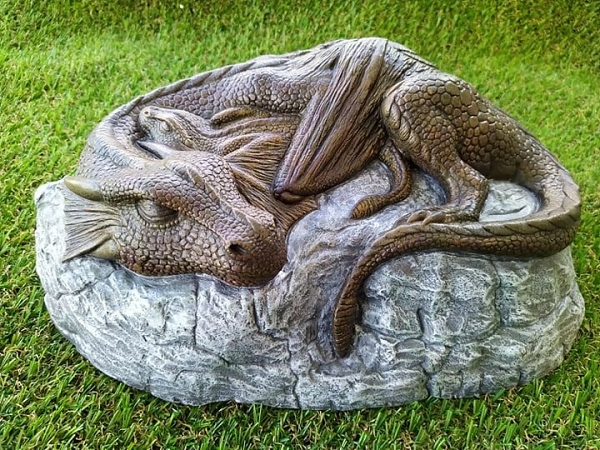 Dragon and her baby sleeping on a rock front view garden ornament