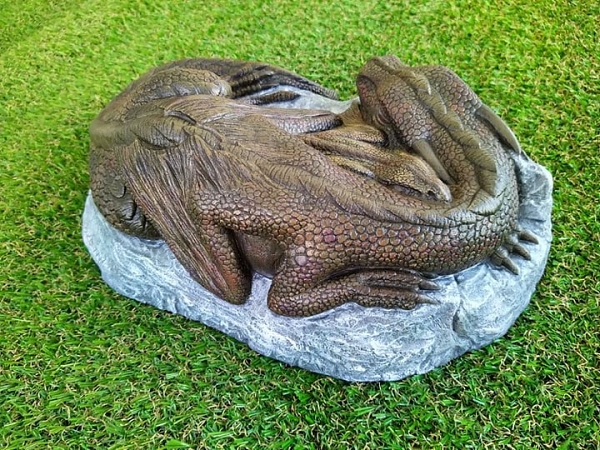 Dragon and her baby sleeping on a rock back wing view garden ornament