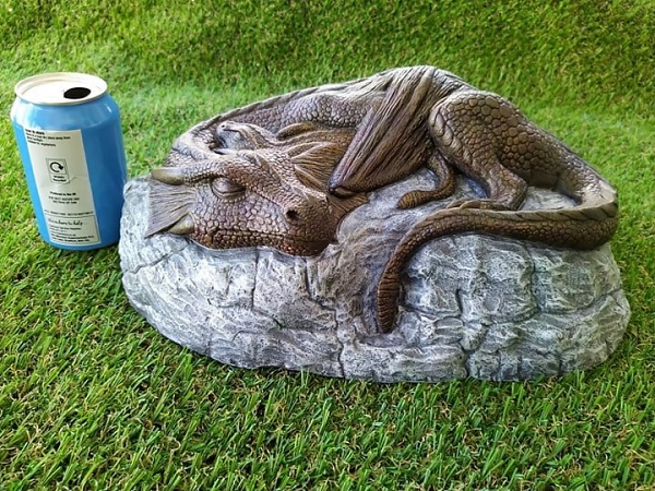 Dragon and her baby sleeping on a rock with drinks can for size garden ornament